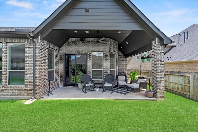 907 Falcon Hollow Ln, Pinehurst, TX 77362 - back of house with brick siding, a patio, and an outdoor living space
