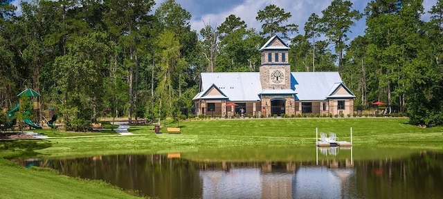 907 Falcon Hollow Ln, Pinehurst, TX 77362 - exterior space with a water view, a playground, and a yard