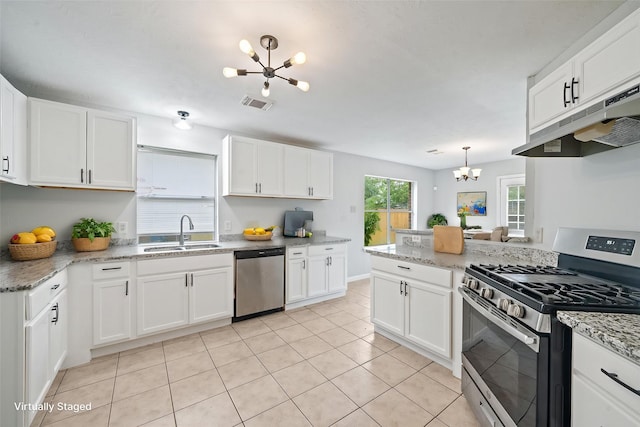 kitchen featuring stainless steel appliances, a chandelier, a sink, light tile patterned flooring, and white cabinetry