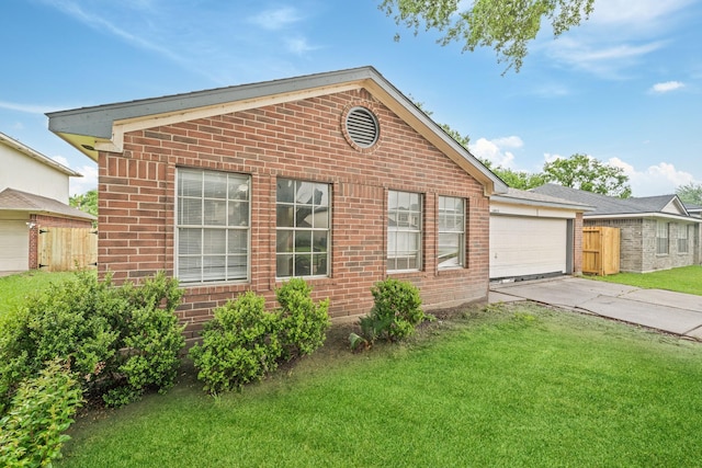 view of side of home featuring driveway, brick siding, and an attached garage