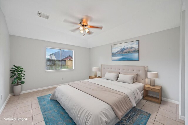 bedroom with light tile patterned floors, baseboards, and ceiling fan