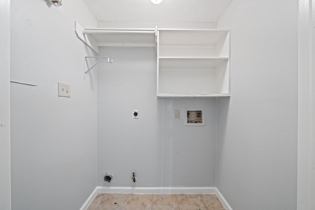 laundry area with hookup for an electric dryer, hookup for a washing machine, gas dryer hookup, and baseboards