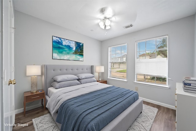 bedroom with baseboards and wood finished floors