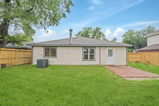 rear view of house with central AC unit and a patio