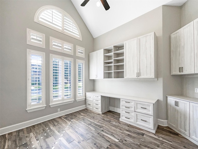 13830 Campwood Ln, Cypress, TX 77429 - unfurnished office featuring a ceiling fan, built in desk, wood finished floors, high vaulted ceiling, and baseboards