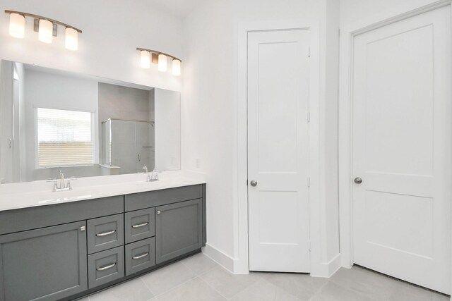 4706 Vaughan St, Iowa Colony, TX 77583 - bathroom featuring a stall shower, tile patterned flooring, double vanity, and baseboards