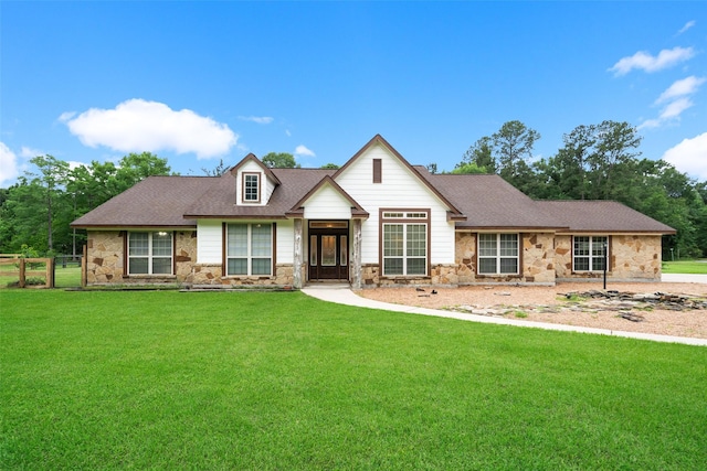 309 County Road 3665 E, Splendora, TX 77372 - view of front facade with stone siding and roof with shingles