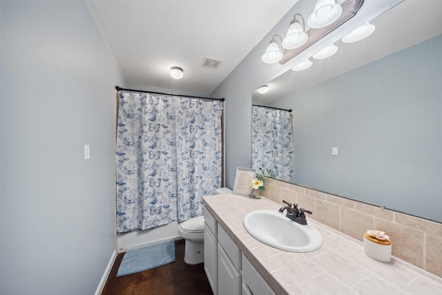 309 County Road 3665 E, Splendora, TX 77372 - bathroom featuring toilet, vanity, baseboards, and backsplash