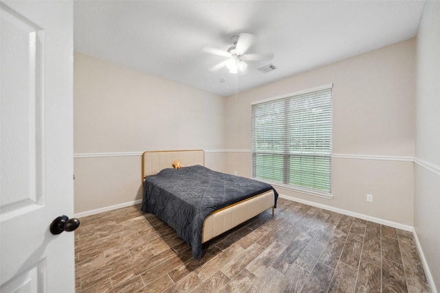 309 County Road 3665 E, Splendora, TX 77372 - bedroom featuring wood finished floors, baseboards, and ceiling fan