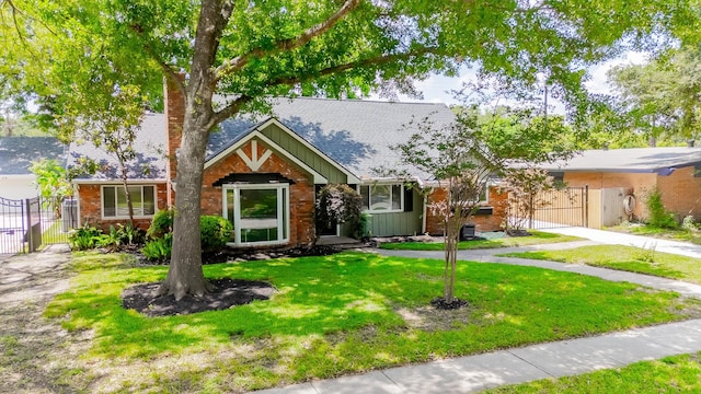 9210 Linkmeadow Ln, Houston, TX 77025 - view of front of home with a gate, board and batten siding, a chimney, a shingled roof, and brick siding