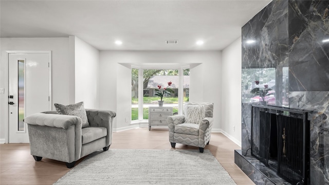 9210 Linkmeadow Ln, Houston, TX 77025 - living area with wood finished floors, a high end fireplace, recessed lighting, and baseboards