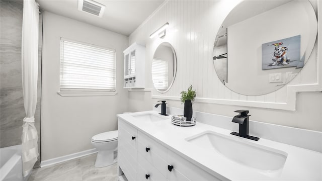 9210 Linkmeadow Ln, Houston, TX 77025 - full bathroom featuring toilet, baseboards, and double vanity