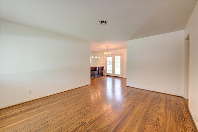 4538 Warm Springs Rd, Houston, TX 77035 - unfurnished room featuring wood finished floors, a chandelier, and baseboards