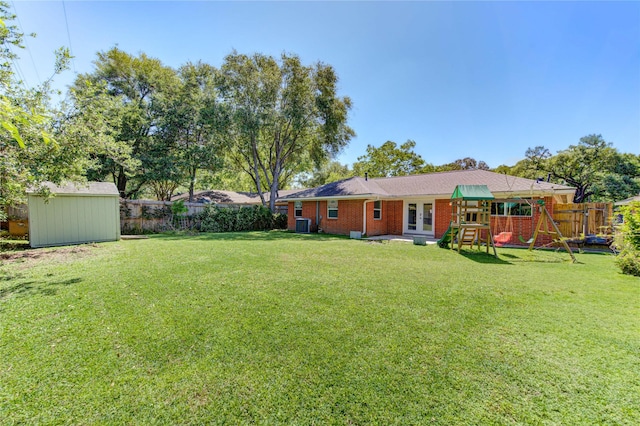 4538 Warm Springs Rd, Houston, TX 77035 - view of yard featuring french doors, a shed, a playground, and an outbuilding