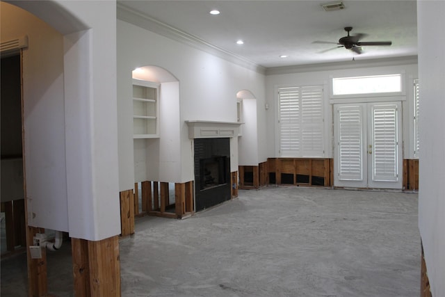 unfurnished living room featuring ornamental molding, a ceiling fan, arched walkways, a fireplace, and recessed lighting