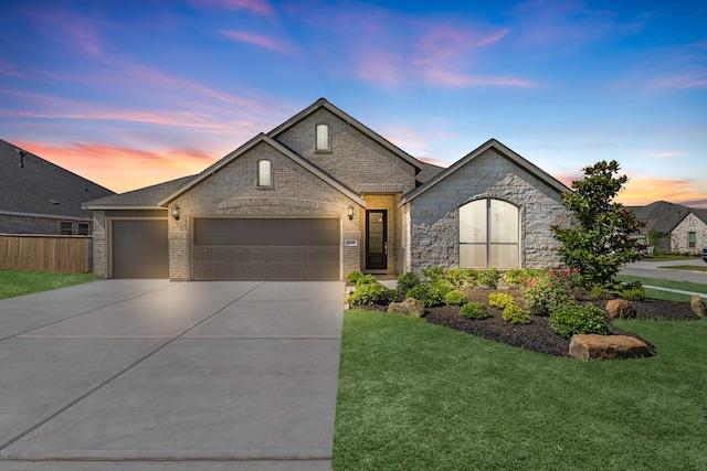 9639 Sterling Arbor Dr, Baytown, TX 77521 - french country home with an attached garage, driveway, brick siding, and stone siding