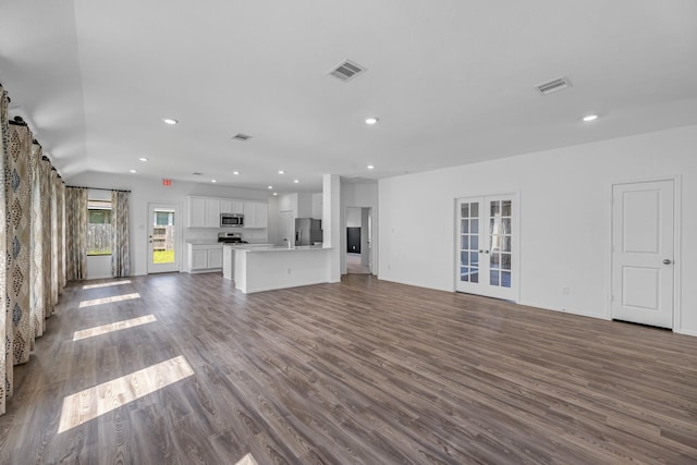 9639 Sterling Arbor Dr, Baytown, TX 77521 - unfurnished living room with french doors, dark wood-style flooring, and recessed lighting