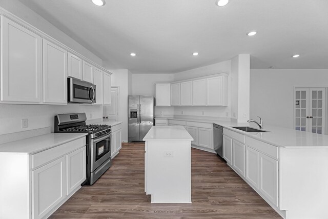 9639 Sterling Arbor Dr, Baytown, TX 77521 - kitchen with appliances with stainless steel finishes, a sink, a peninsula, a kitchen island, and recessed lighting