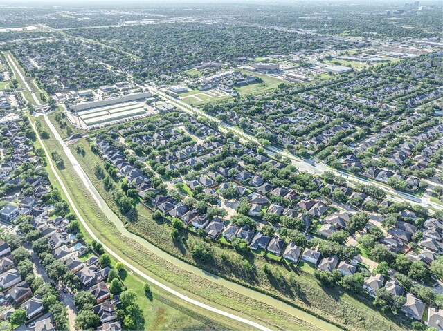 aerial view of property and surrounding area featuring nearby suburban area