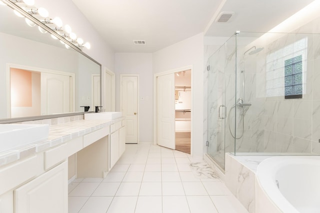 full bathroom with a marble finish shower, a garden tub, double vanity, and tile patterned floors
