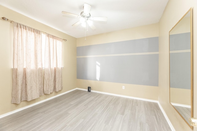 unfurnished room featuring wood finished floors, ceiling fan, and baseboards