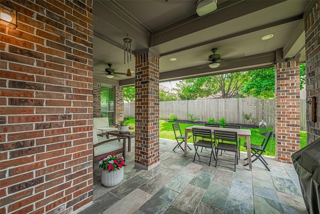 view of patio / terrace with ceiling fan, outdoor dining space, and a fenced backyard