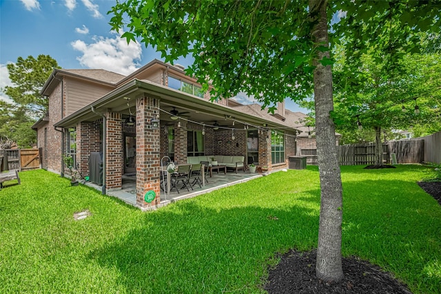 back of house featuring ceiling fan, an outdoor hangout area, a patio, and brick siding