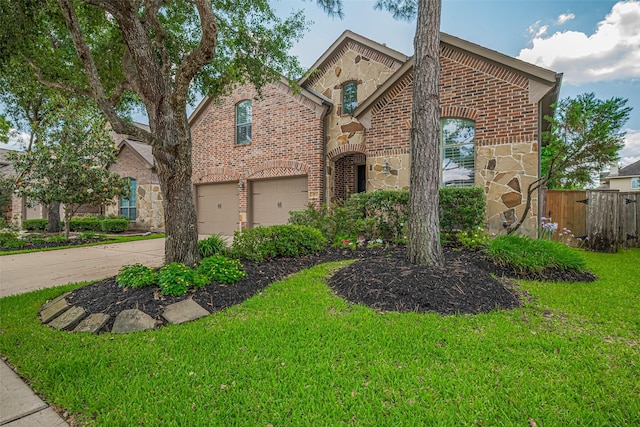 view of front of home featuring brick siding, stone siding, a garage, and driveway