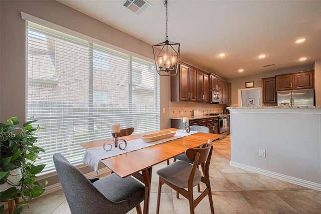 dining space featuring a chandelier, light tile patterned flooring, recessed lighting, and baseboards