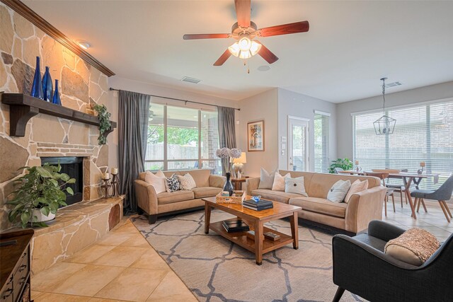living room with light tile patterned floors, healthy amount of natural light, and a ceiling fan