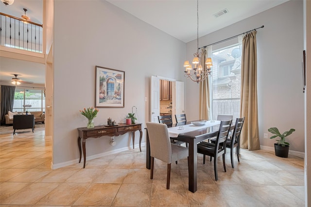 dining space with high vaulted ceiling, a chandelier, baseboards, light tile patterned flooring, and ceiling fan
