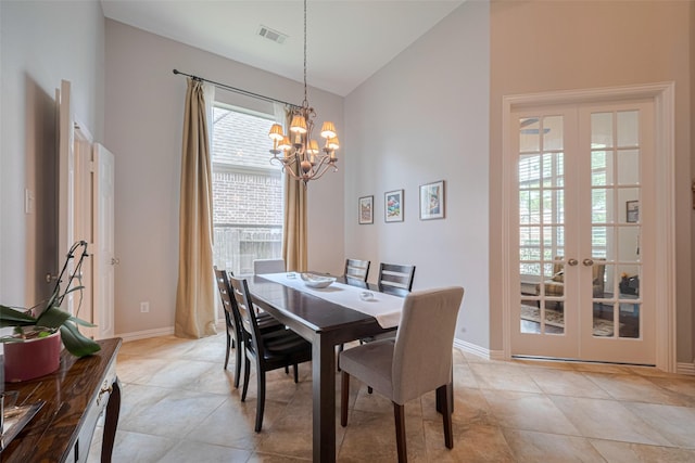 dining space featuring a chandelier, light tile patterned flooring, baseboards, french doors, and high vaulted ceiling
