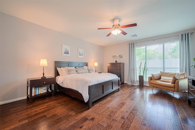 bedroom with dark wood-type flooring, ceiling fan, and baseboards