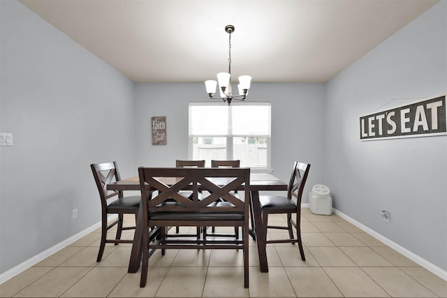 dining space with a chandelier, light tile patterned flooring, and baseboards
