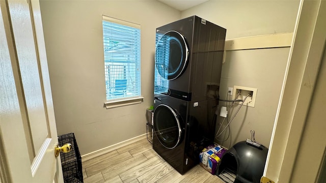 3615 Huggins Way St, Pearland, TX 77584 - laundry room with stacked washer and clothes dryer, baseboards, and light wood finished floors