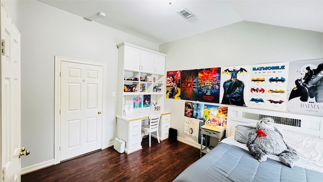 bedroom with dark wood-type flooring, lofted ceiling, and baseboards