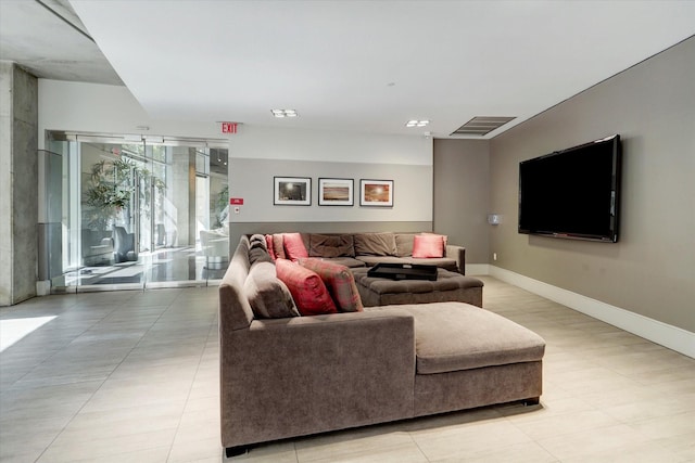 living room with baseboards and light tile patterned flooring