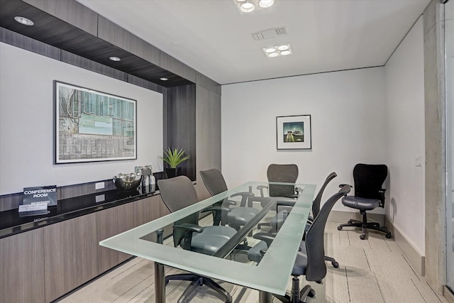 office space with baseboards and light wood-style floors