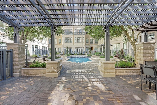 community pool featuring fence, a pergola, and a patio area