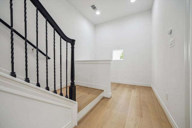 2813 Clinton Dr, Houston, TX 77020 - stairs with wood finished floors, baseboards, and recessed lighting