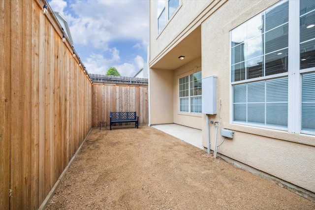 2813 Clinton Dr, Houston, TX 77020 - view of home's exterior with fence, a patio area, and stucco siding