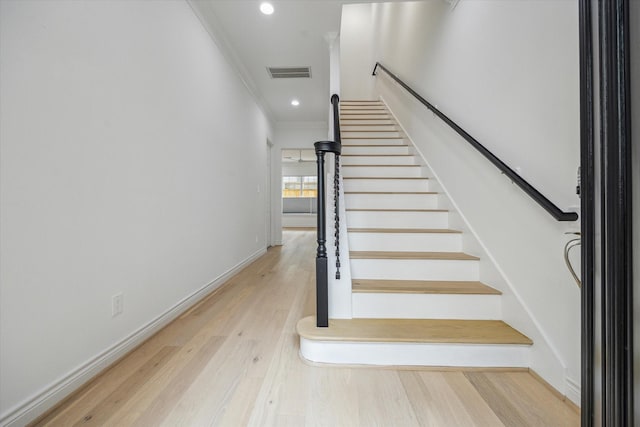 2813 Clinton Dr, Houston, TX 77020 - staircase with crown molding, wood finished floors, recessed lighting, and baseboards