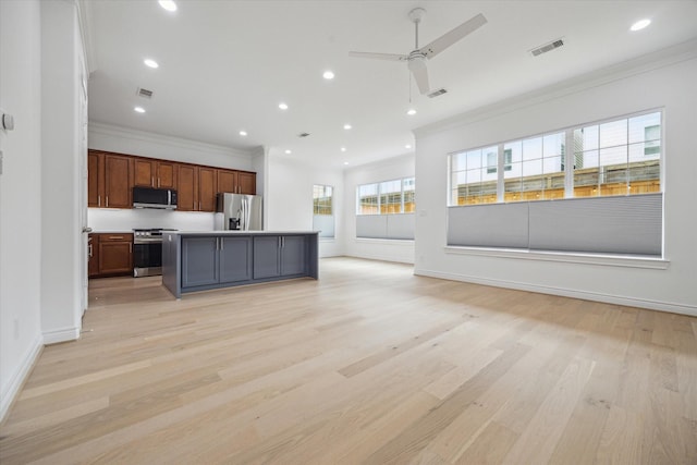 2813 Clinton Dr, Houston, TX 77020 - kitchen featuring appliances with stainless steel finishes, open floor plan, a ceiling fan, ornamental molding, and recessed lighting