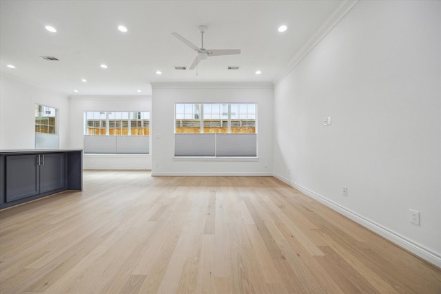 2813 Clinton Dr, Houston, TX 77020 - unfurnished living room featuring ornamental molding, healthy amount of natural light, light wood-type flooring, recessed lighting, and baseboards