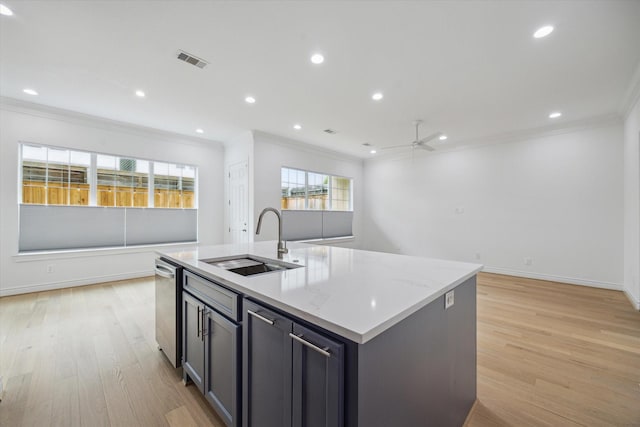 2813 Clinton Dr, Houston, TX 77020 - kitchen featuring a sink, ornamental molding, open floor plan, light wood-style floors, and a center island with sink