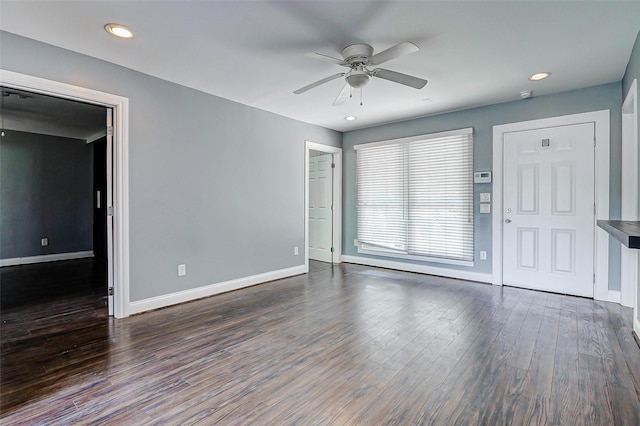 spare room featuring a ceiling fan, baseboards, dark wood-style flooring, and recessed lighting