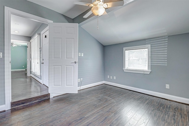 additional living space with ceiling fan, vaulted ceiling, healthy amount of natural light, baseboards, and wood finished floors
