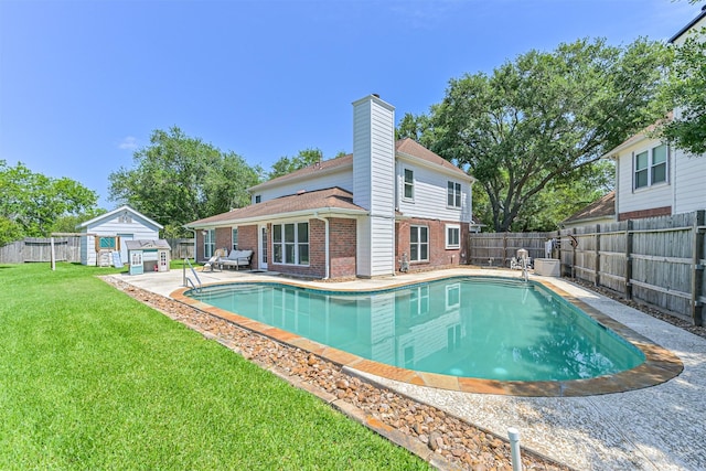 view of pool with a patio area and an outdoor structure