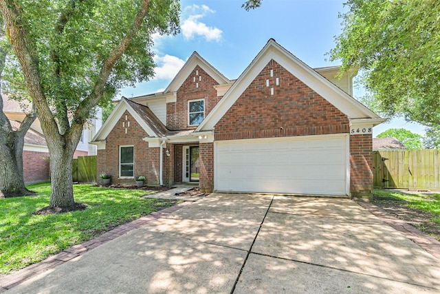 traditional-style house with driveway, brick siding, and a garage