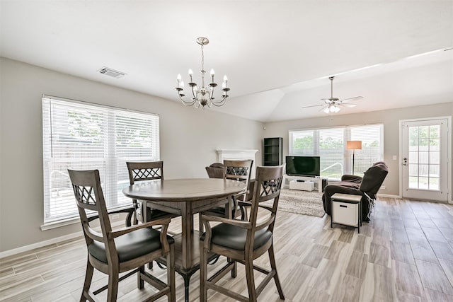 dining room with plenty of natural light, light wood-type flooring, baseboards, and a chandelier